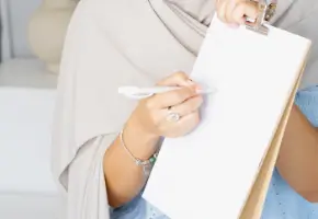 Professional holding documents while reviewing industry white paper research and insights